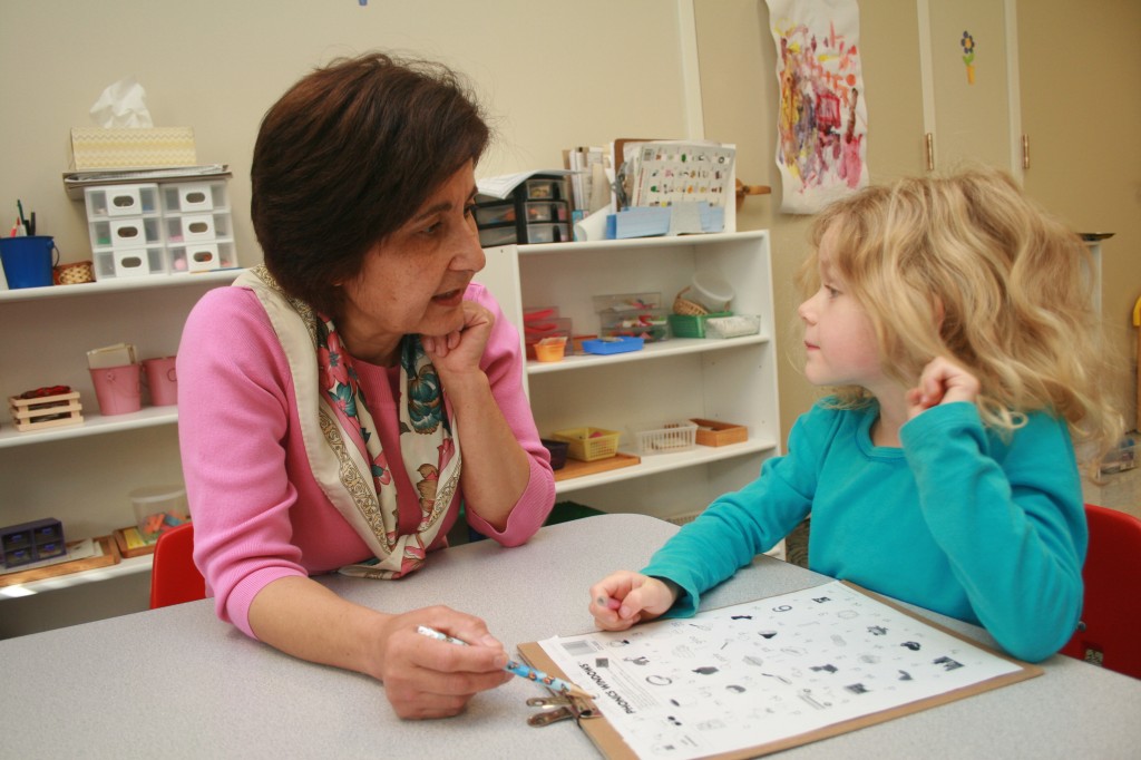 Ms. Ruhi working with child.