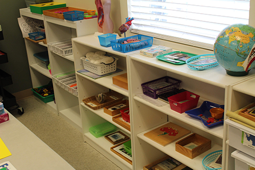 Shelves of activities in the Early Elementary classroom.