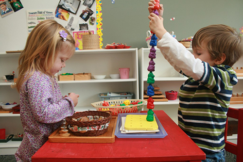 Two children working on activities.