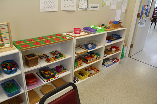 Shelves of activities in the Early Elementary classroom.