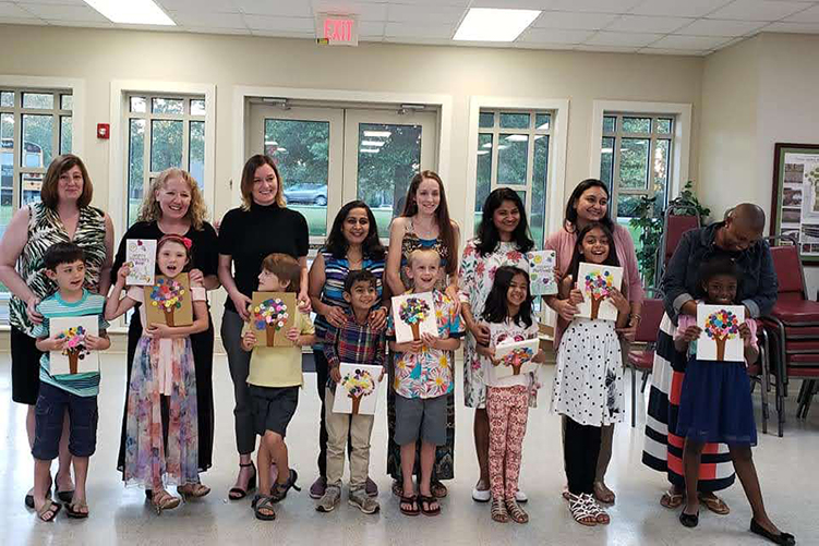 Children with their mothers at the Mother's Day Dinner.