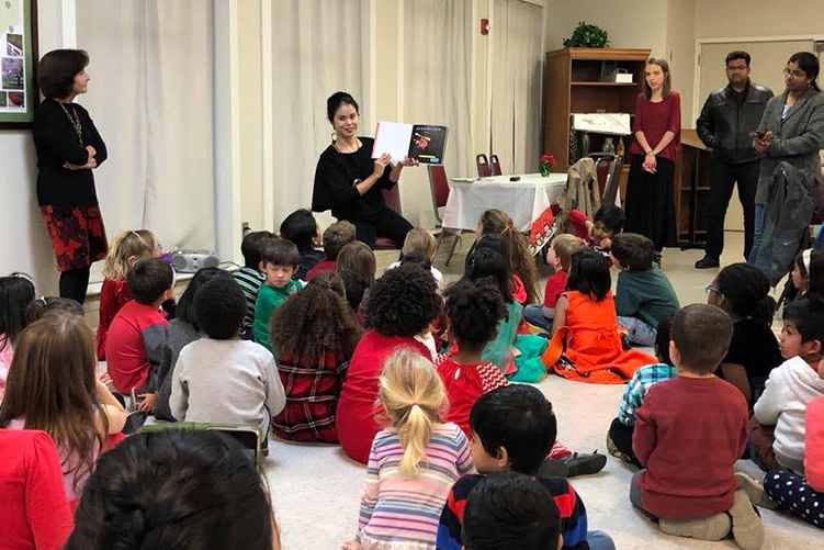 Parent reading to group at the International Dinner.